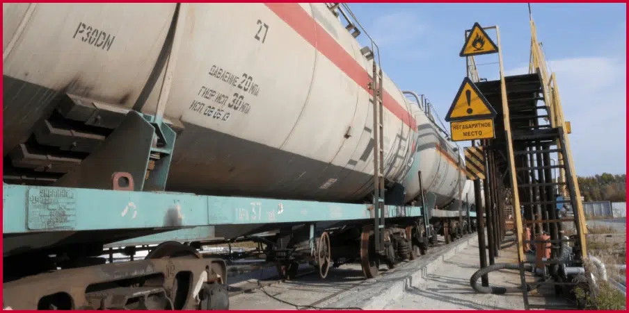 Tankcar railcar at a loading station, designed for transporting liquids or gases, showcasing its structure and industrial use