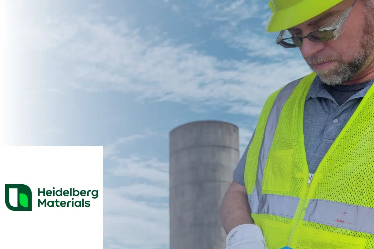 Heidelberg Materials logo and a plant operator in a high‑visibility vest at a cement facility, illustrating a WingScan cement volume scanner case study and real‑time material monitoring